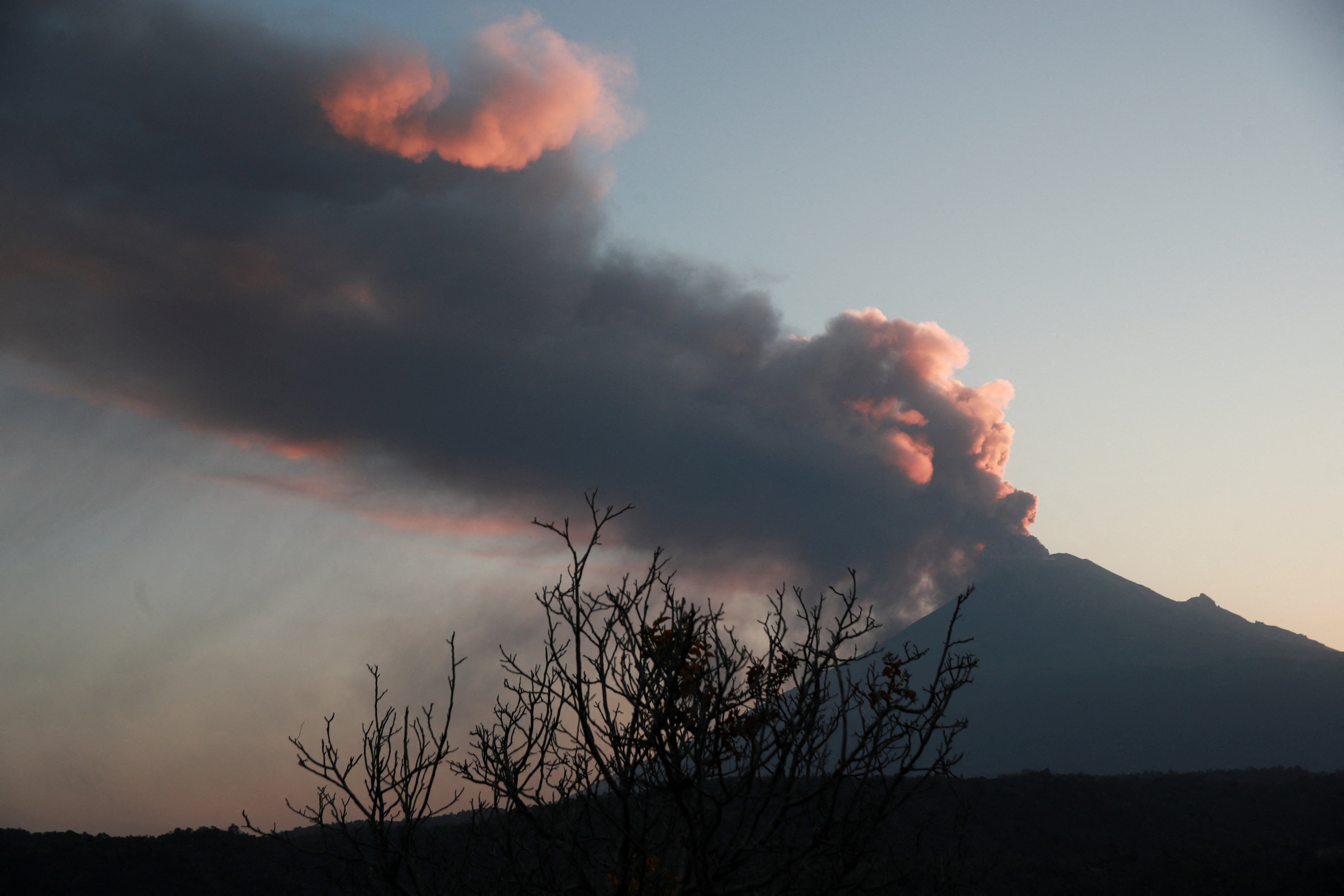 Popocatepetl volcano spews a column of ash and smoke as authorities declare a yellow alert
