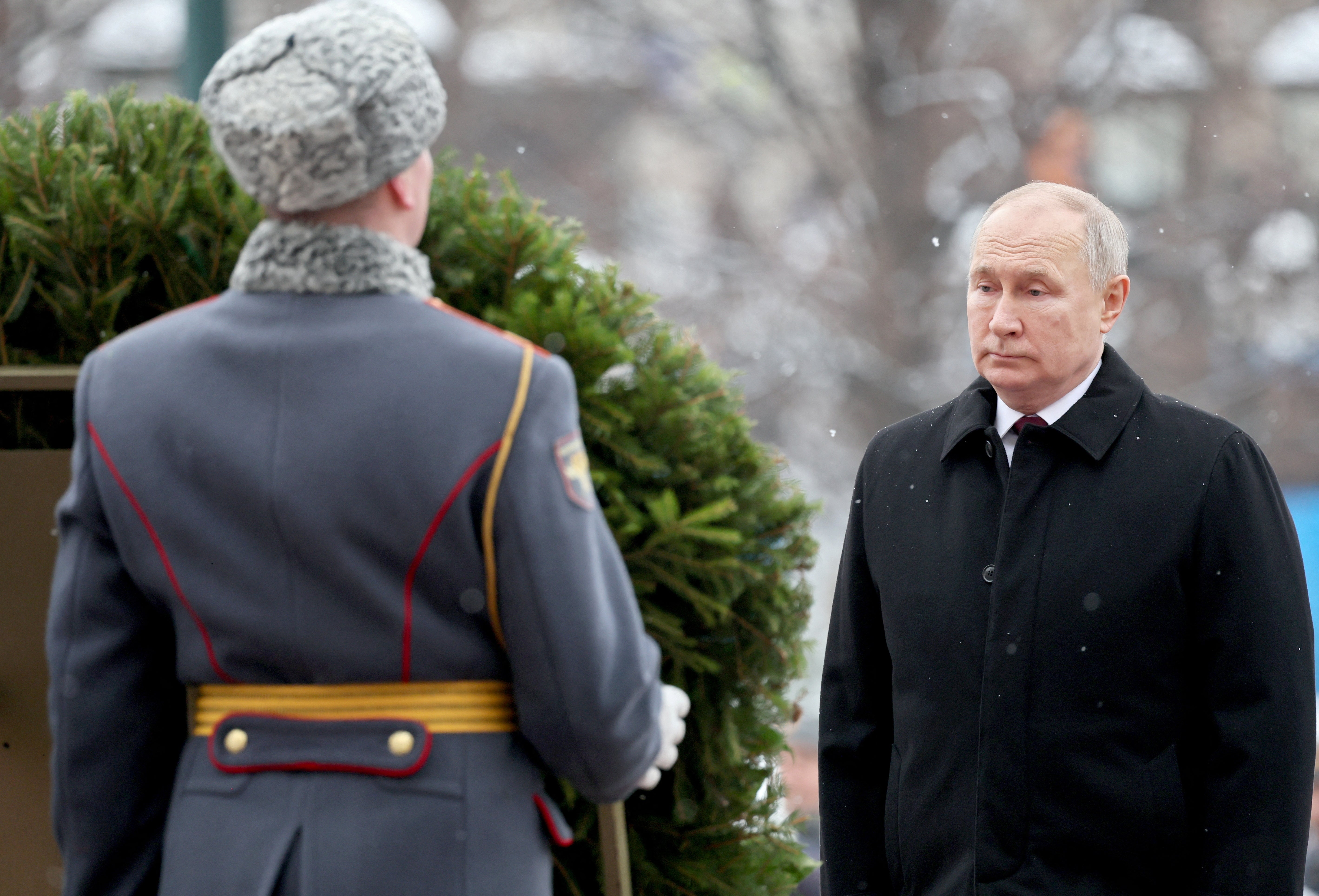 President Vladimir Putin takes part in a wreath laying ceremony marking Defender of the Fatherland Day at the Tomb of the Unknown Soldier by the Kremlin Wall in Moscow