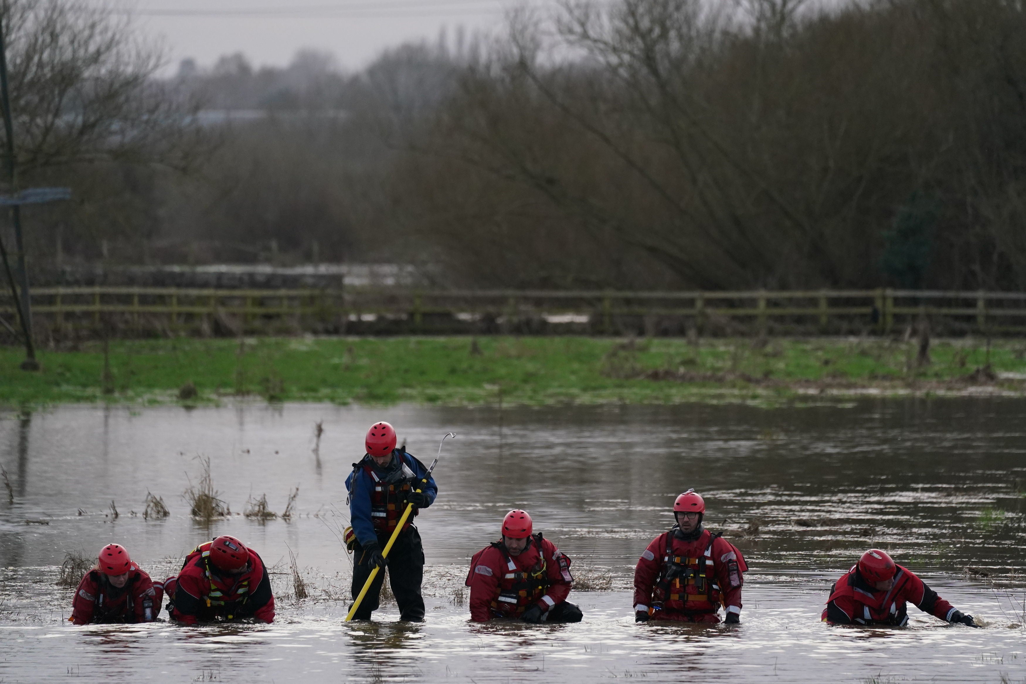 Rescue workers on their hands and knees searching for Xielo