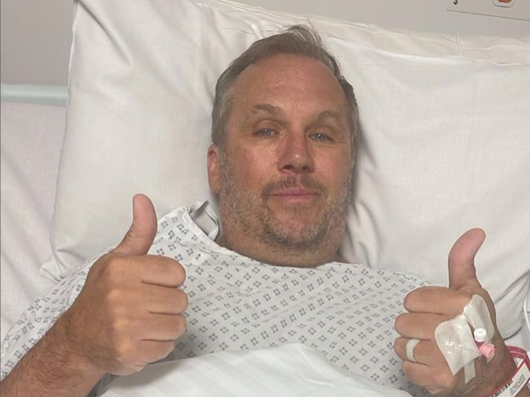 Andrews shared an image from his hospital bed and shared he was ‘happy to have woken up’