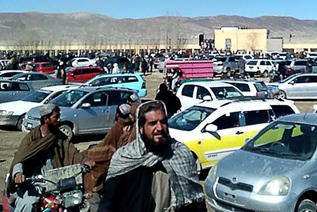 <p>Afghan men leaving a football stadium after attending the public execution by Taliban authorities of two men convicted of murder, in Ghazni</p>