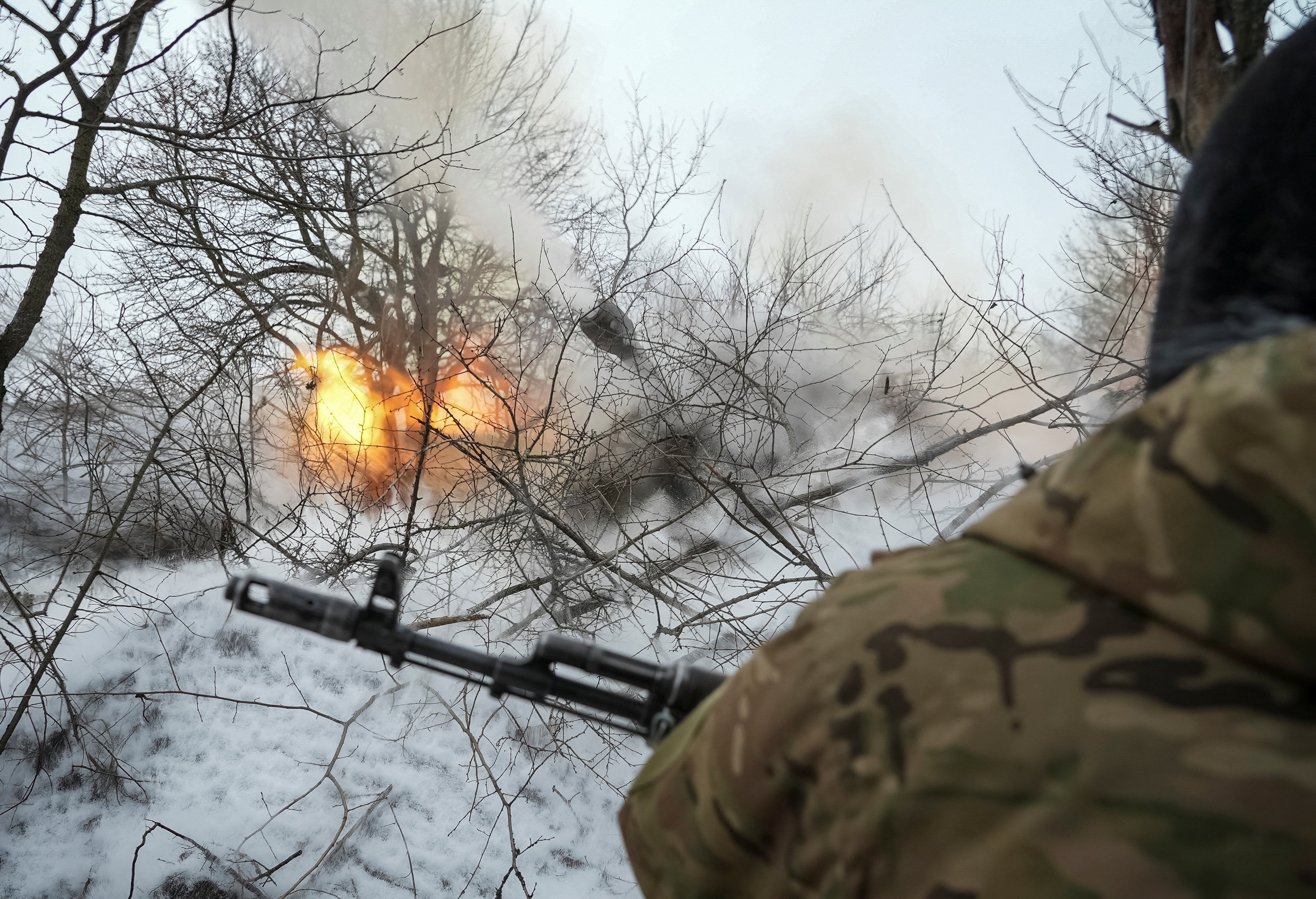 A Ukrainian serviceman with the 93rd Brigade fires a howitzer towards Russian troops, near the city of Chasiv Yar in Donetsk