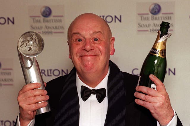 John Savident celebrating Coronation Street winning best soap at the British Soap Awards in 1999 (PA)