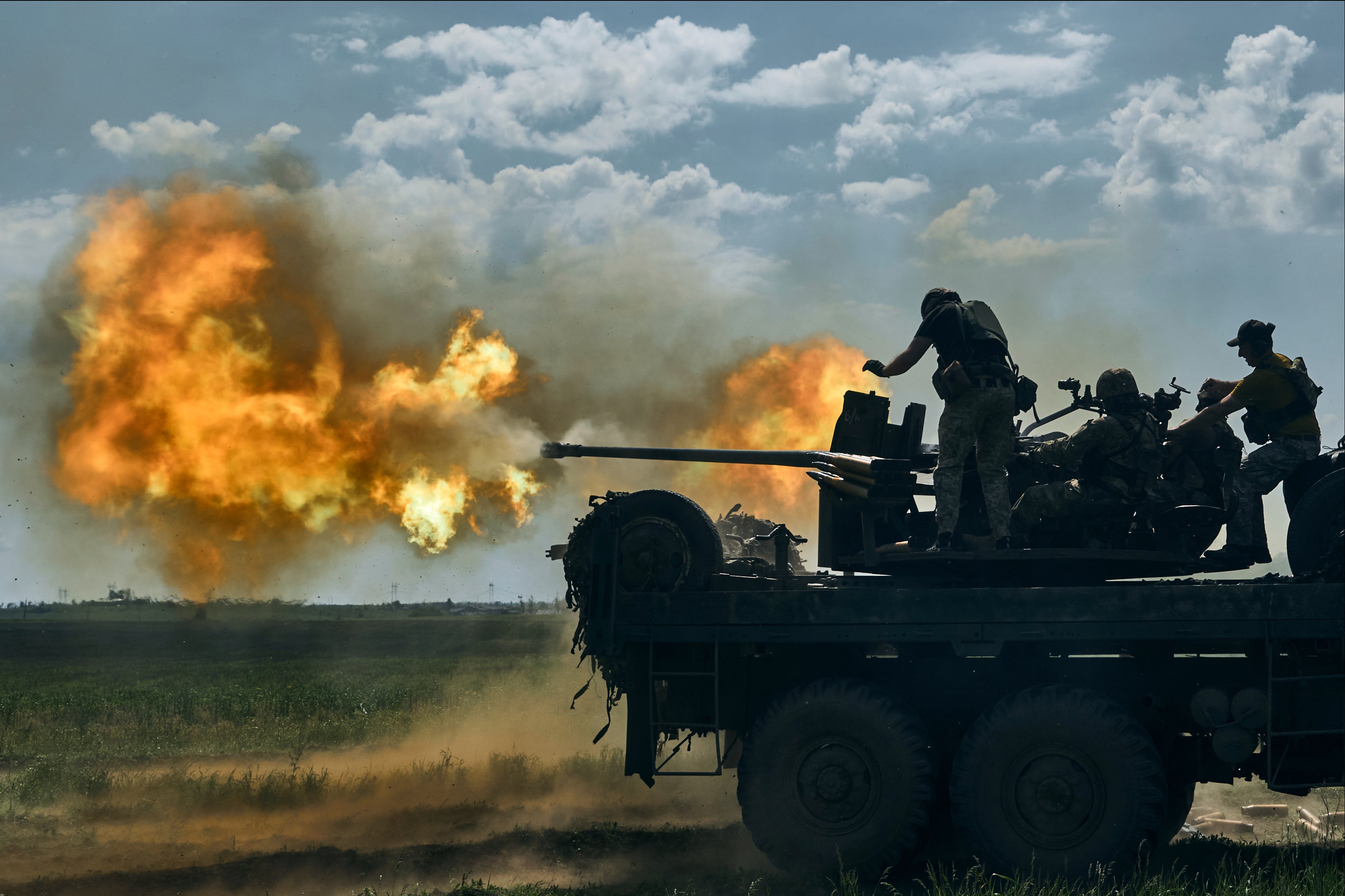 Ukrainian soldiers fire a cannon near the eastern city of Bakhmut in the Donetsk region