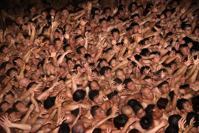 <p>Approximately 9,000 men in loincloths try to snatch a lucky wooden stick during the ‘Eyo’ naked festival at Saidaiji Temple </p>
