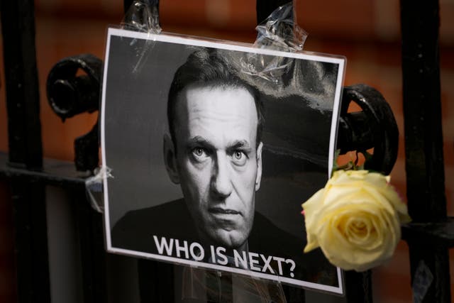<p>A flower and a picture are left as a tribute to Russian politician Alexei Navalny, near to the Russian embassy in London</p>