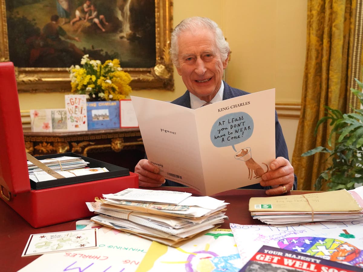 King Charles pictured laughing as he reads card from well-wisher among 7,000 sent since cancer diagnosis