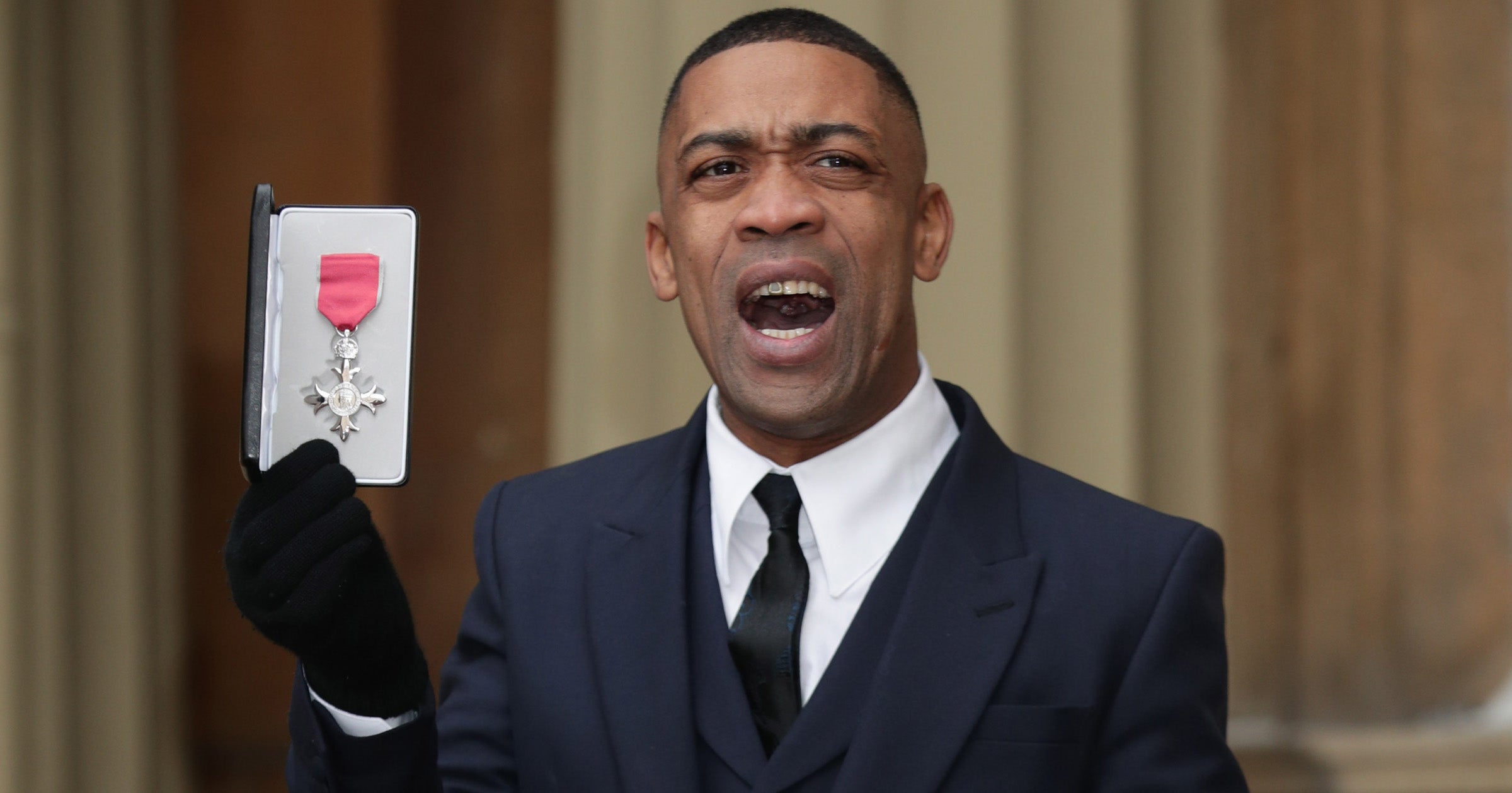 Wiley holding his MBE in 2017