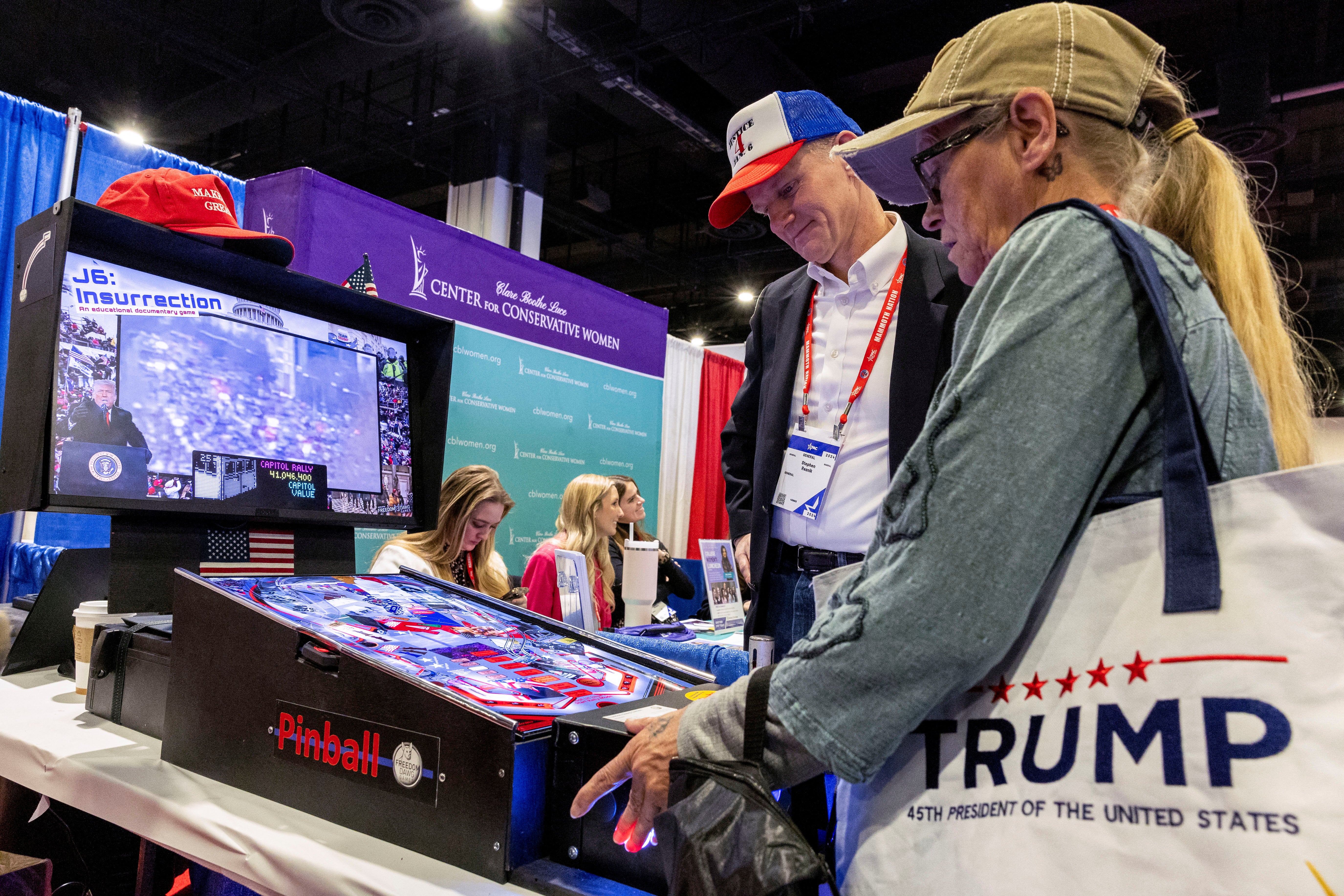 People play a January 6-themed pinball game at the Conservative Political Action Conference (CPAC) annual meeting in National Harbor, Maryland, U.S., February 22, 2024