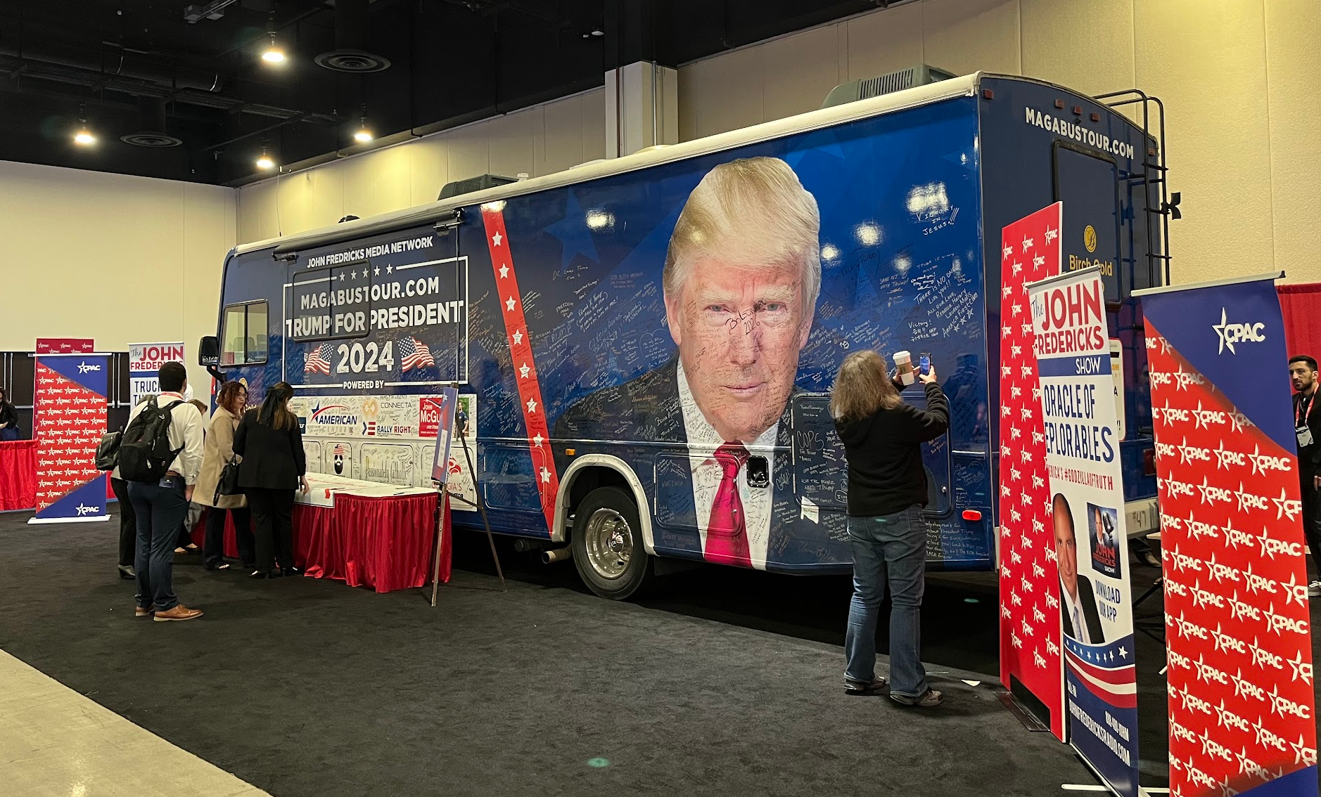 Radio host John Fredericks parked his bus in the exhibition hall for attendees to sign