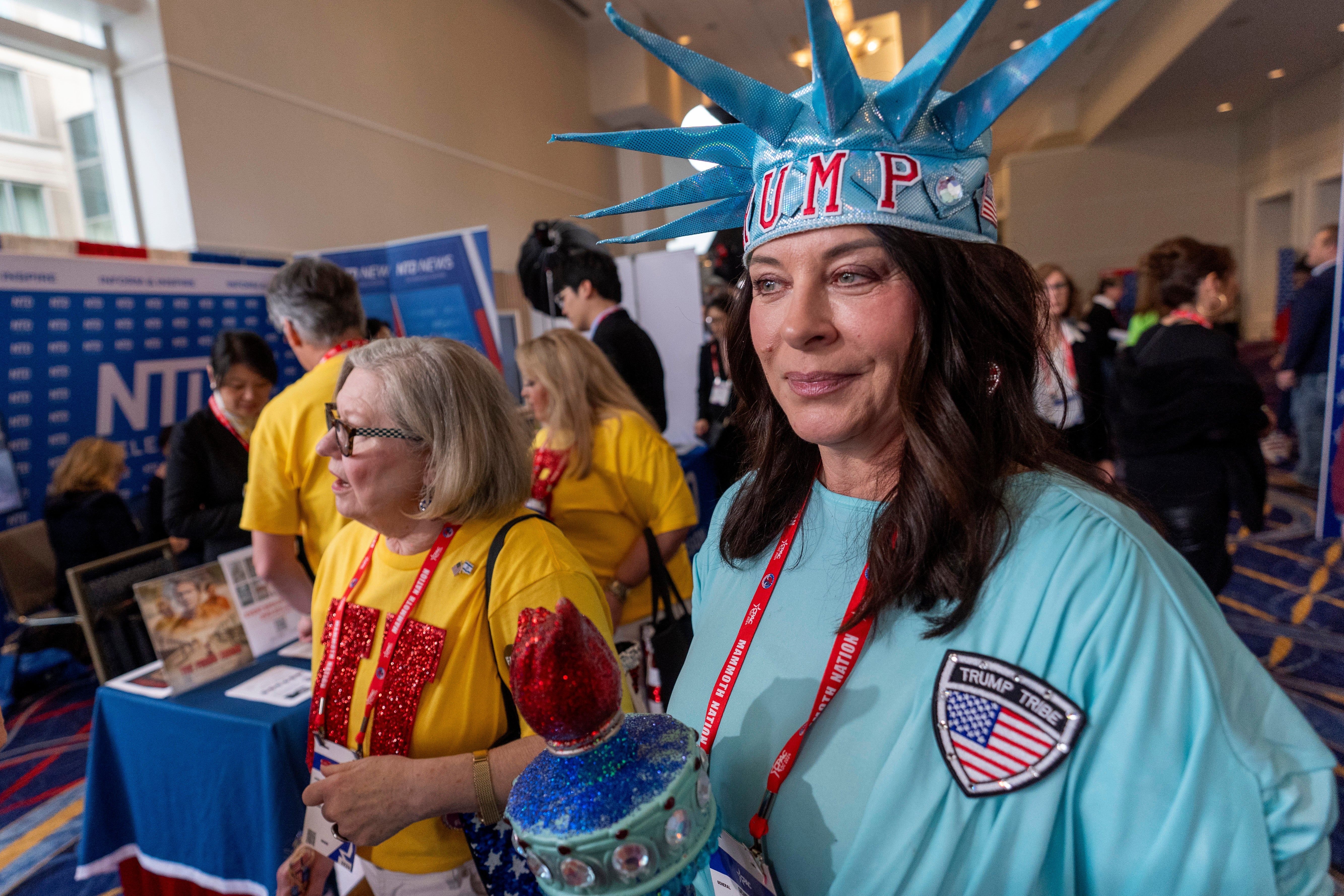 An attendee is dressed as the Statue of Liberty as she walks through the Conservative Political Action Conference, CPAC 2024, at the National Harbor in Oxon Hill, Md., Friday, Feb. 23, 2024
