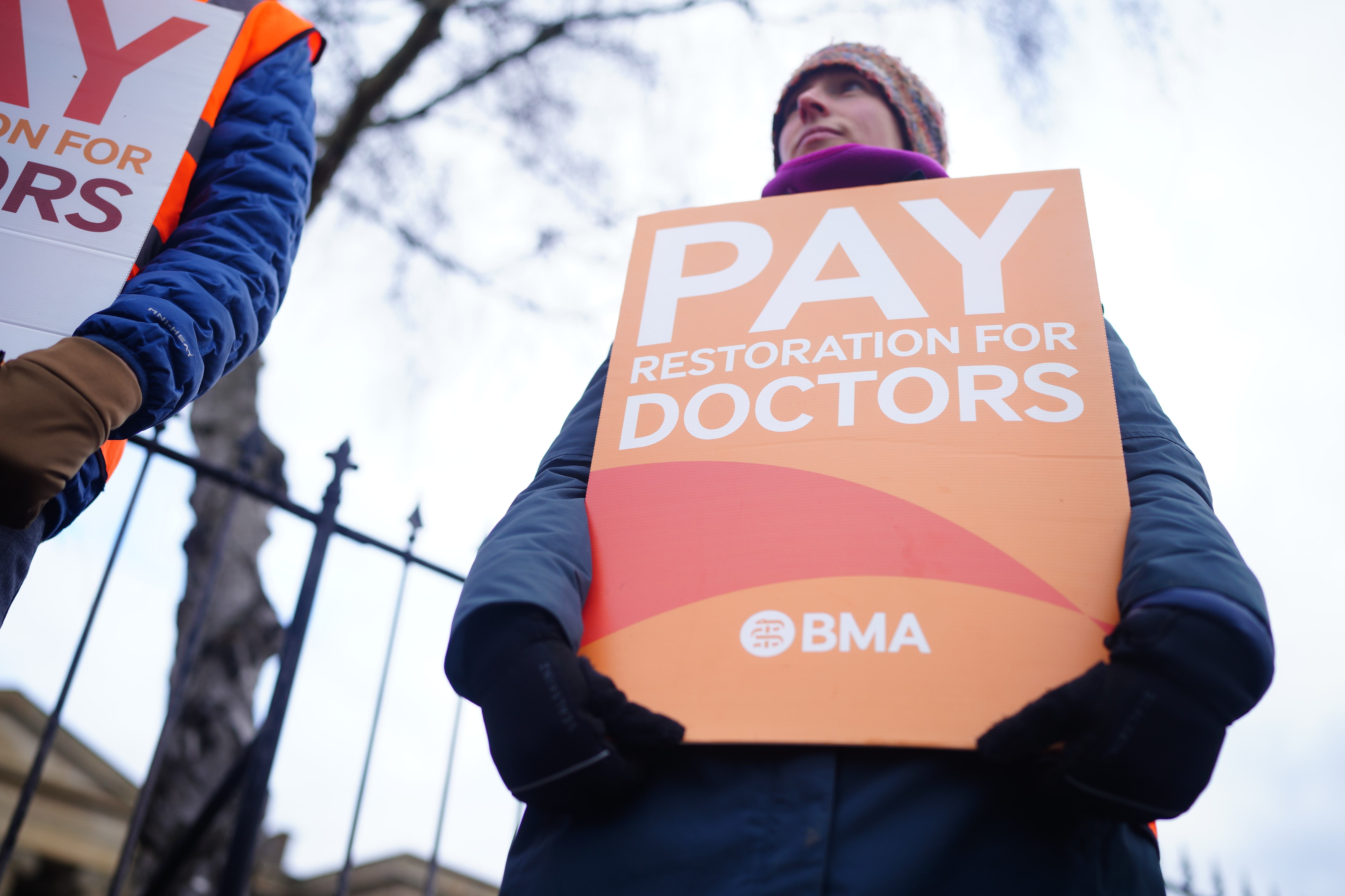 Junior doctors and members of the British Medical Association stand on the picket line outside Cheltenham General Hospital (PA)