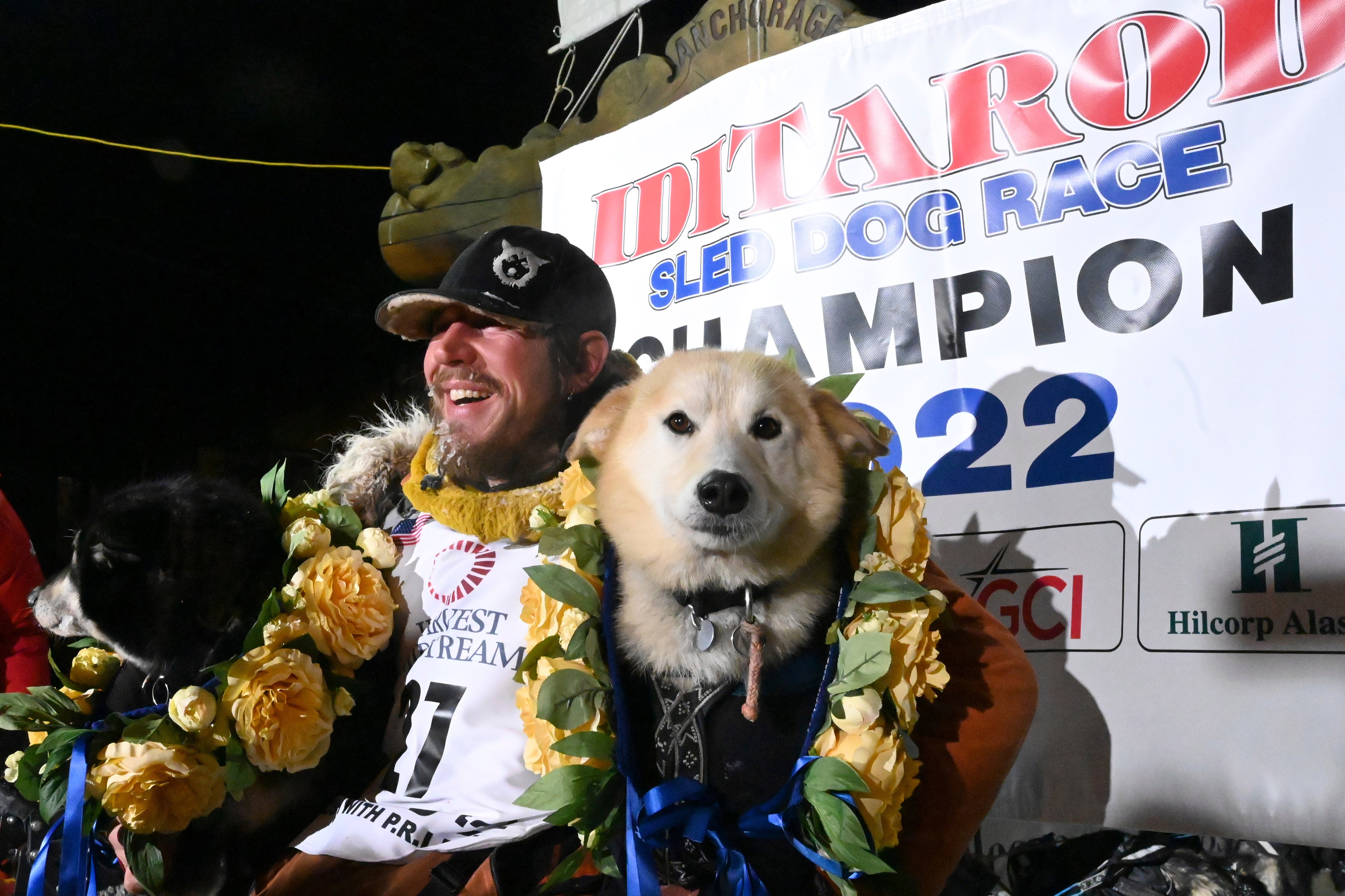 Iditarod winner Brent Sass poses for photos with lead dogs Morello, left, and Slater