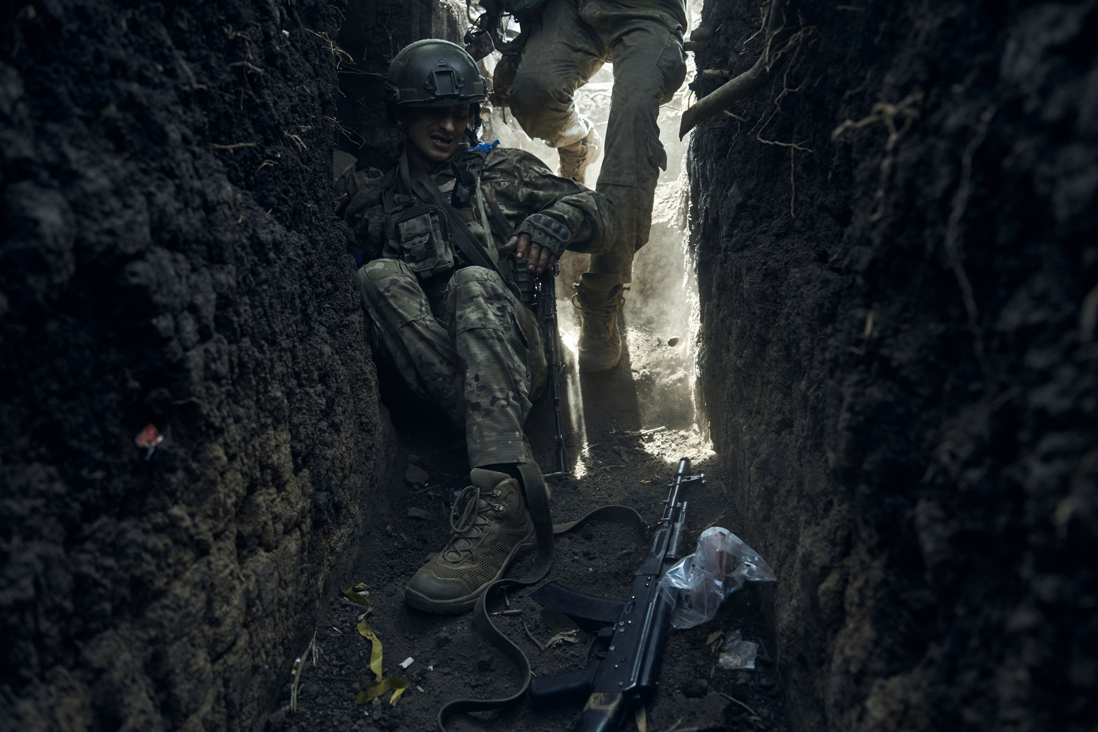 A soldier of Ukraine's 3rd Separate Assault Brigade jumps in a trench under shelling near Bakhmut, eastern Ukraine