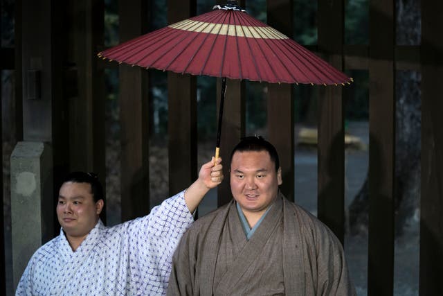 <p>Mongolian-born grand sumo champion Hakuho Sho speaks to the media at the Meiji Jingu Shrine in Tokyo in 2020 </p>