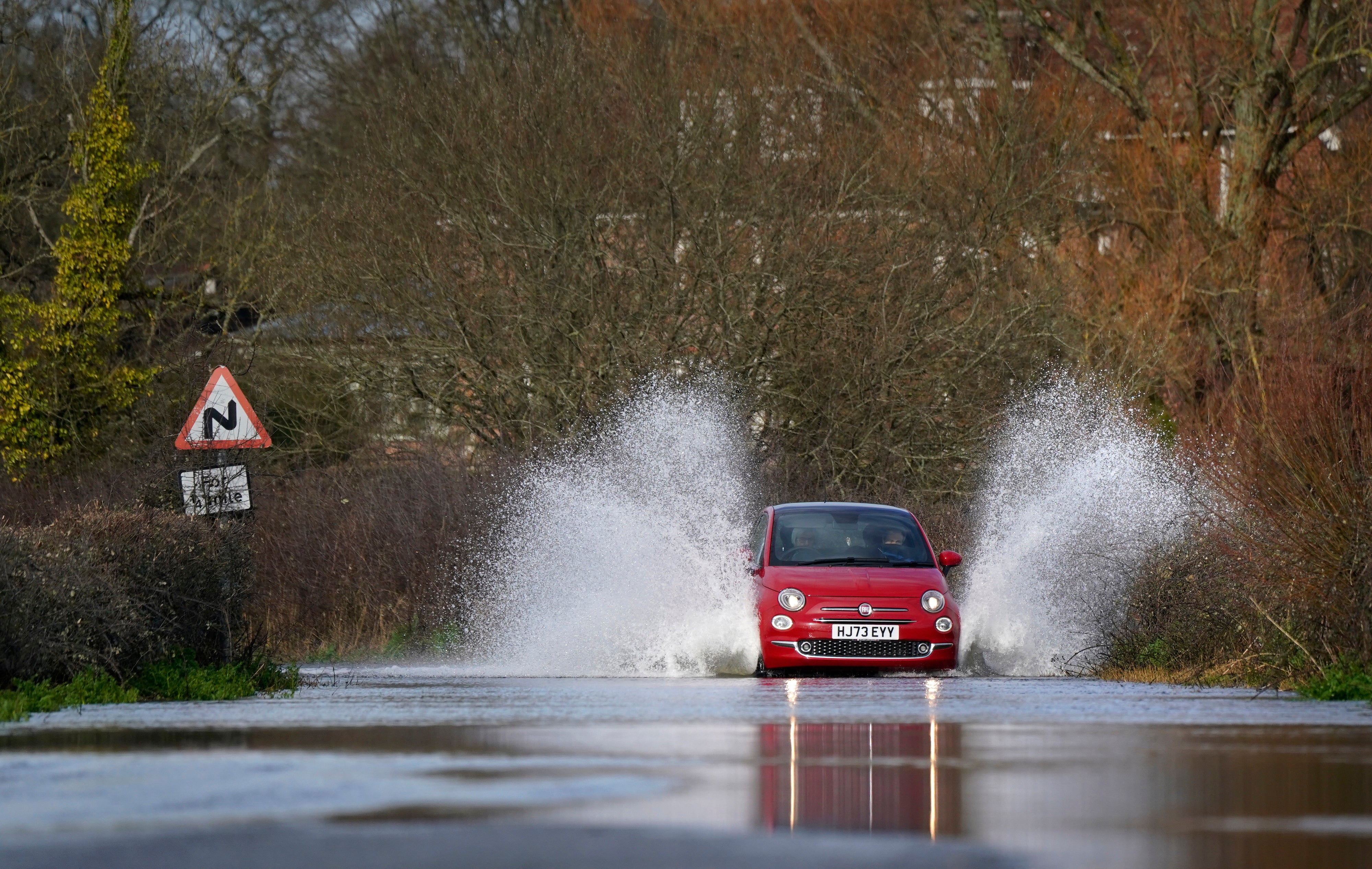 A car drives through floodwater in Harbridge, Hampshire
