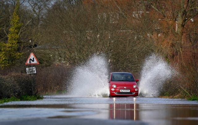 <p>A car drives through floodwater in Harbridge, Hampshire</p>