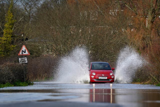 <p>A car drives through floodwater in Harbridge, Hampshire</p>