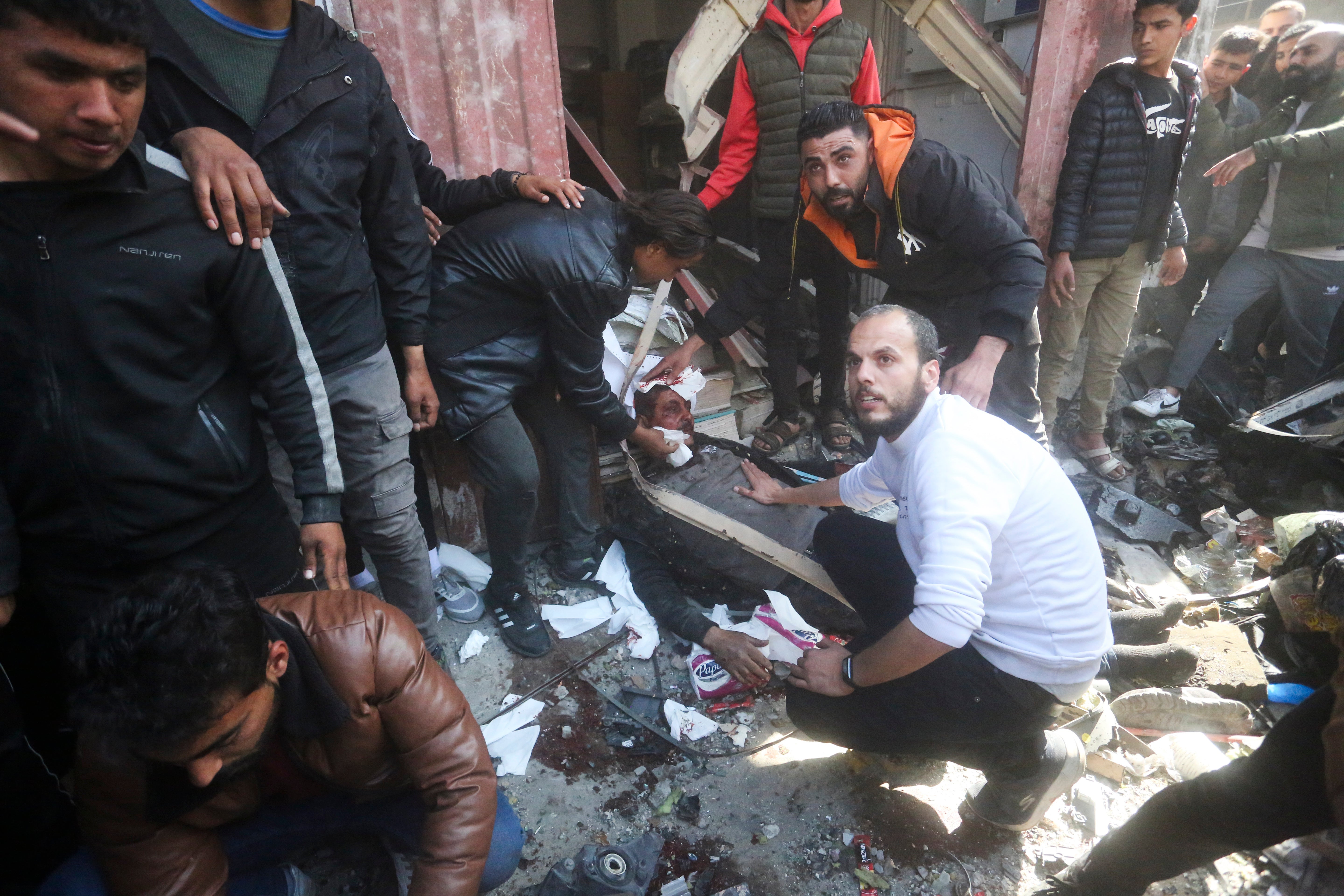 Palestinians rescue survivors after an Israeli strike on Shaheen family house in Rafah