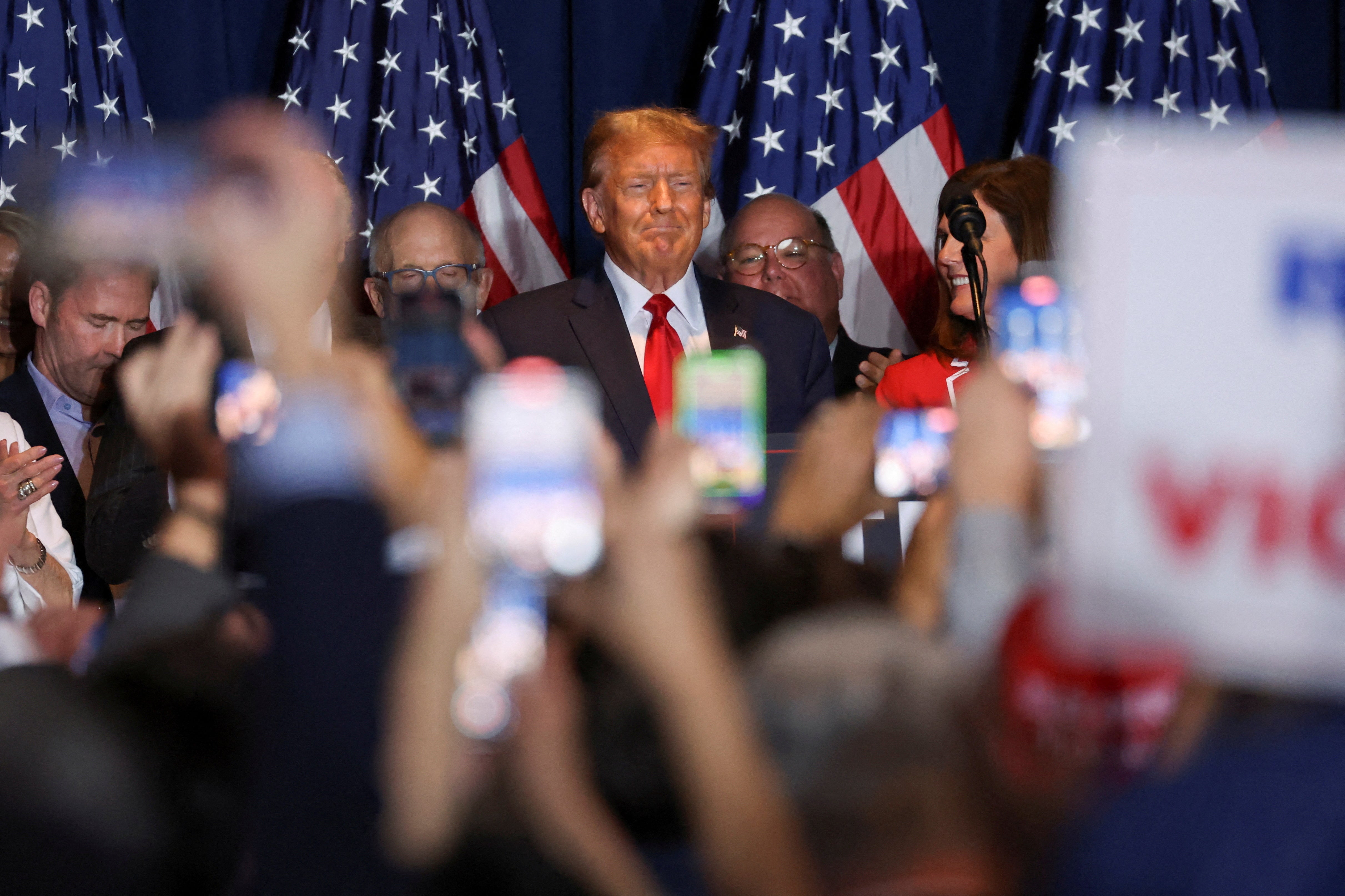 <p>Republican presidential candidate and former US president Donald Trump stands on stage as he hosts a South Carolina Republican presidential primary election night party in Columbia, South Carolina, US, 24 February 2024</p>