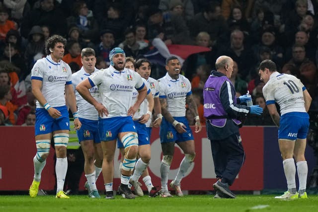 Italy players celebrate after Ange Capuozzo scored a late try in their 13-13 Six Nations draw with France (Lewis Joly/AP)