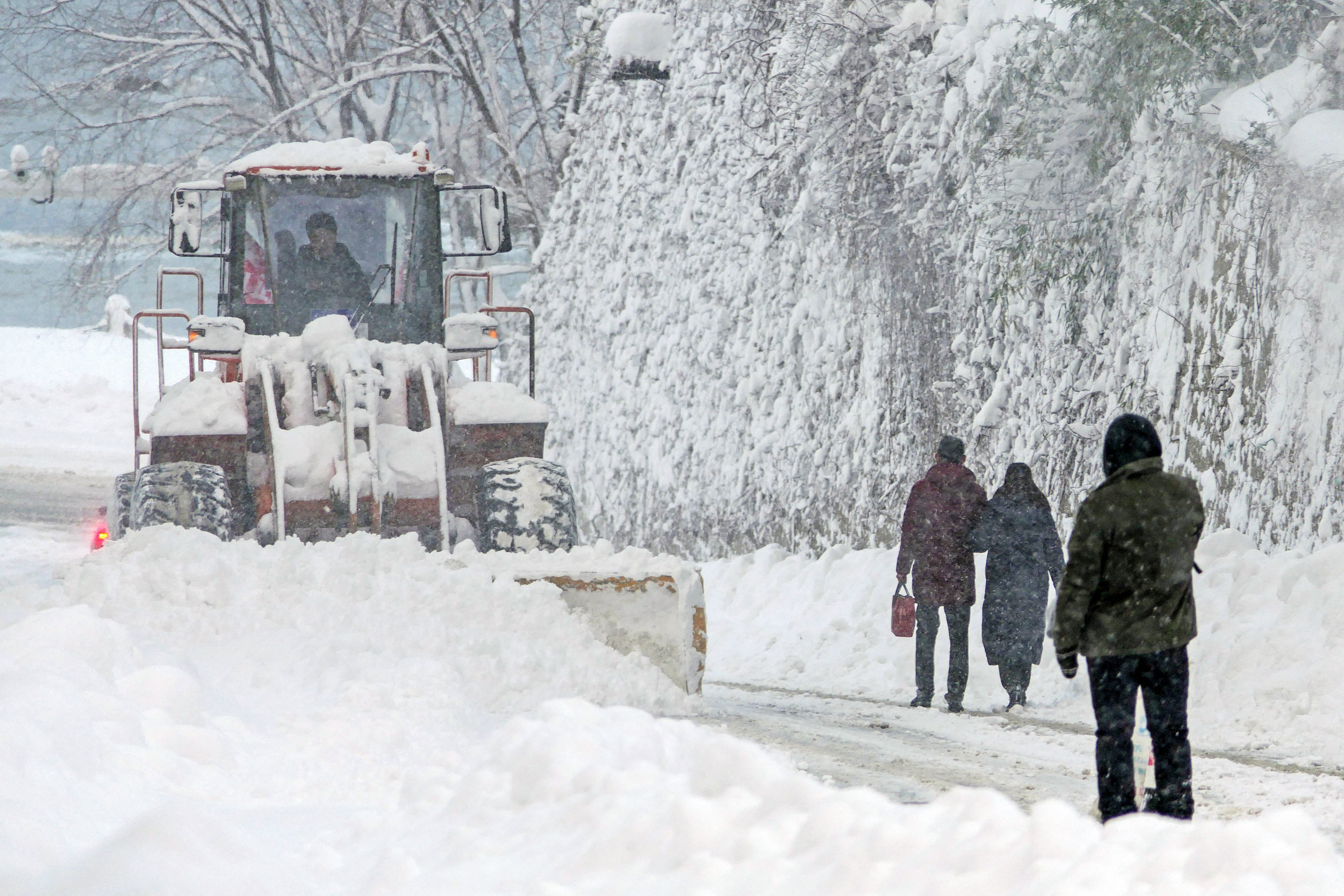 File image: A snowplow clears snow during snowfall in Yantai, in China’s eastern Shandong province