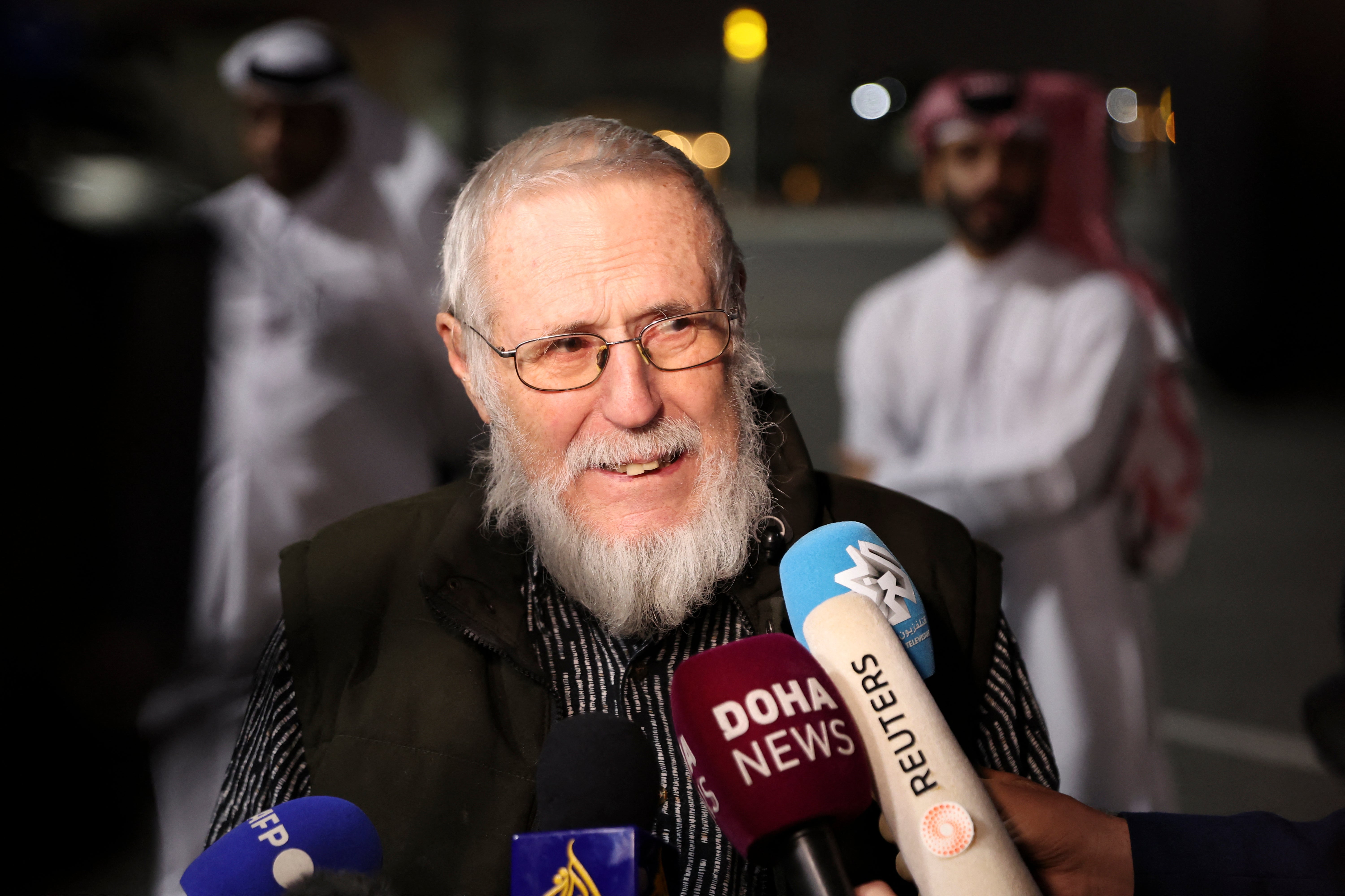 Austrian far-right activist Herbert Fitz talks to the press on his arrival at Doha International Airport following his release from Taliban captivity