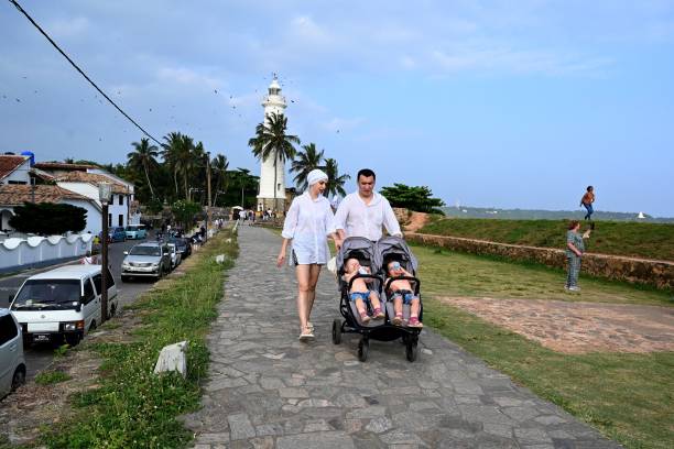 Tourists push a stroller along Galle Fort in Gallehas after Russia’s invasion of Ukraine stranded many people on the tropical island