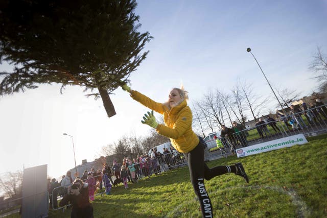 <p>Kamila Grabska is seen as she wins the ladies section in the seventh annual Christmas Tree throwing Championships in Ennis, Co Clare, in 2018 </p>