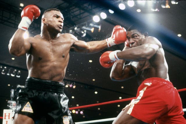 <p>Mike Tyson (left) in action against Frank Bruno in 1989 </p>