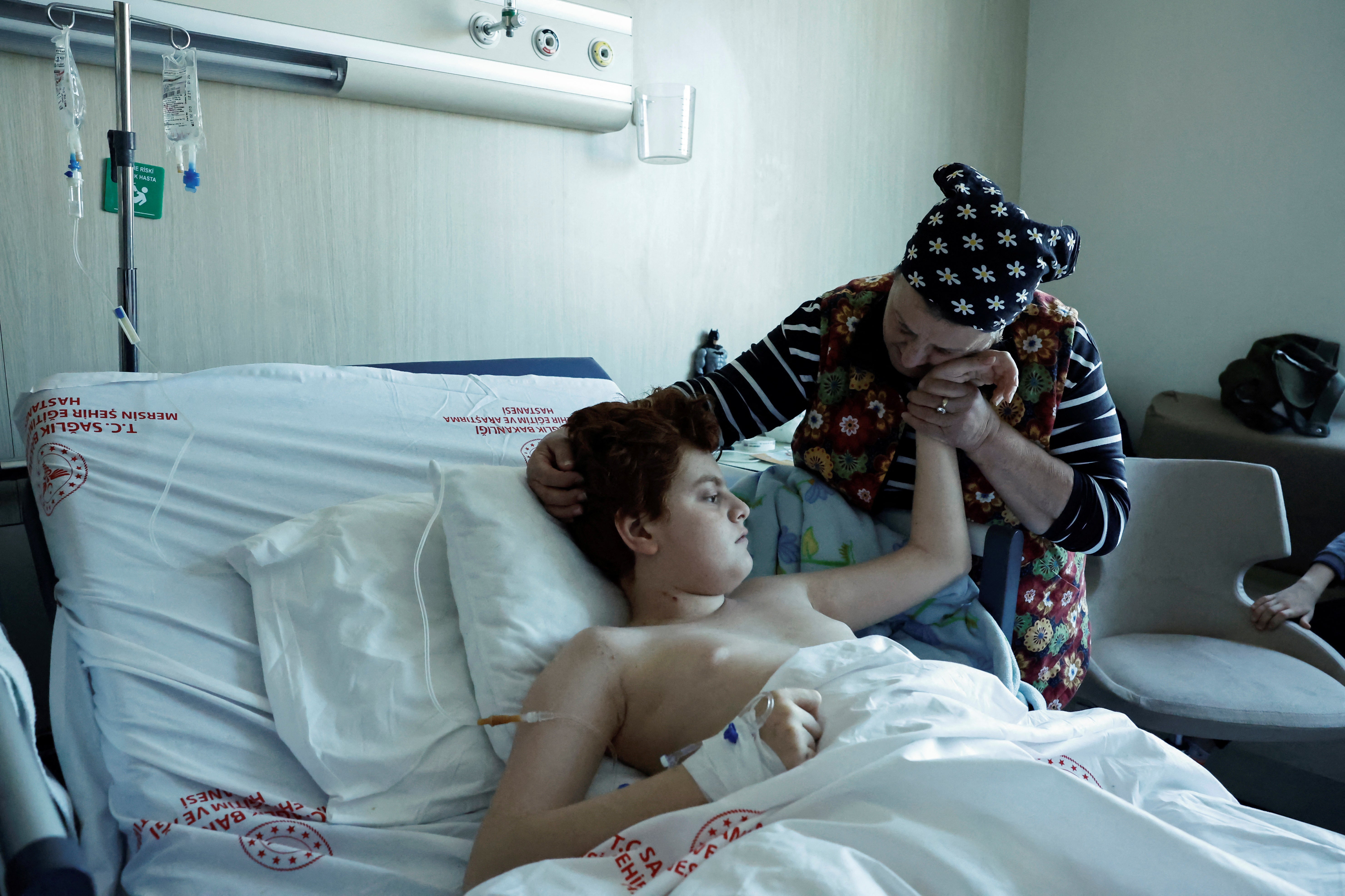 Mehmet is comforted by his grandmother in Mersin hospital