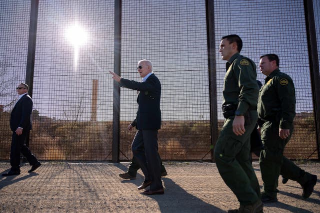 <p>US President Joe Biden walks along the US-Mexico border fence in El Paso, Texas, on 8 January 2023</p>
