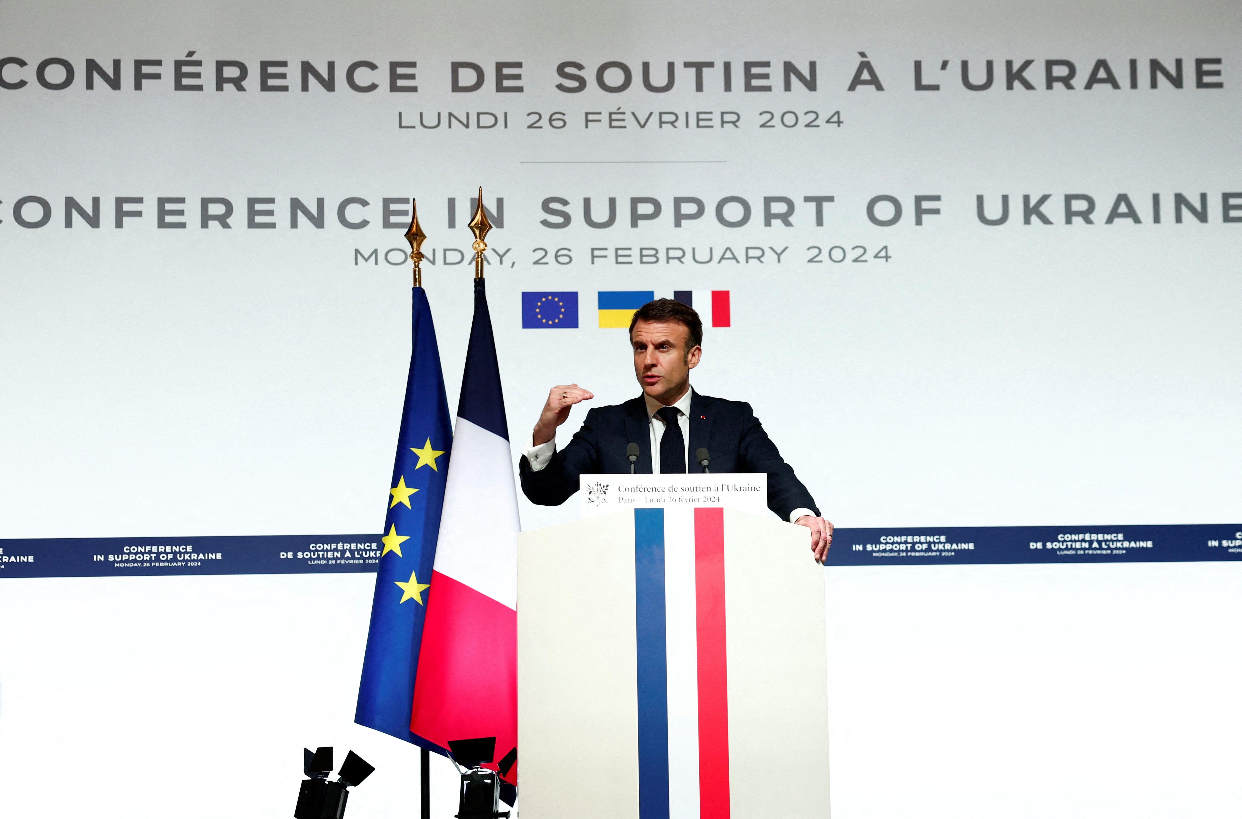 French president Emmanuel Macron speaks to the press at the end of the international conference at the Elysee presidential palace in Paris