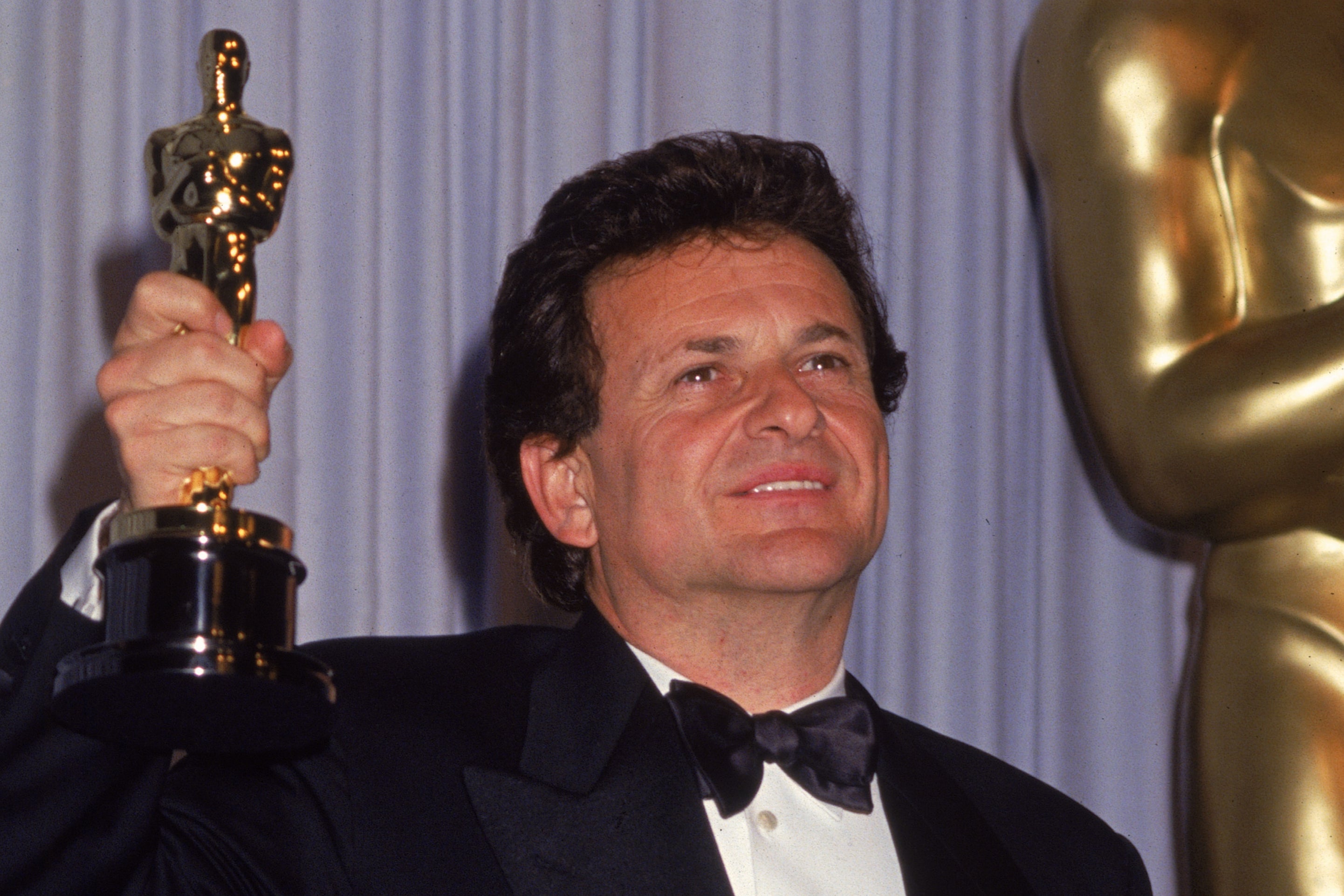 Joe Pesci holding aloft his Oscar in 1991