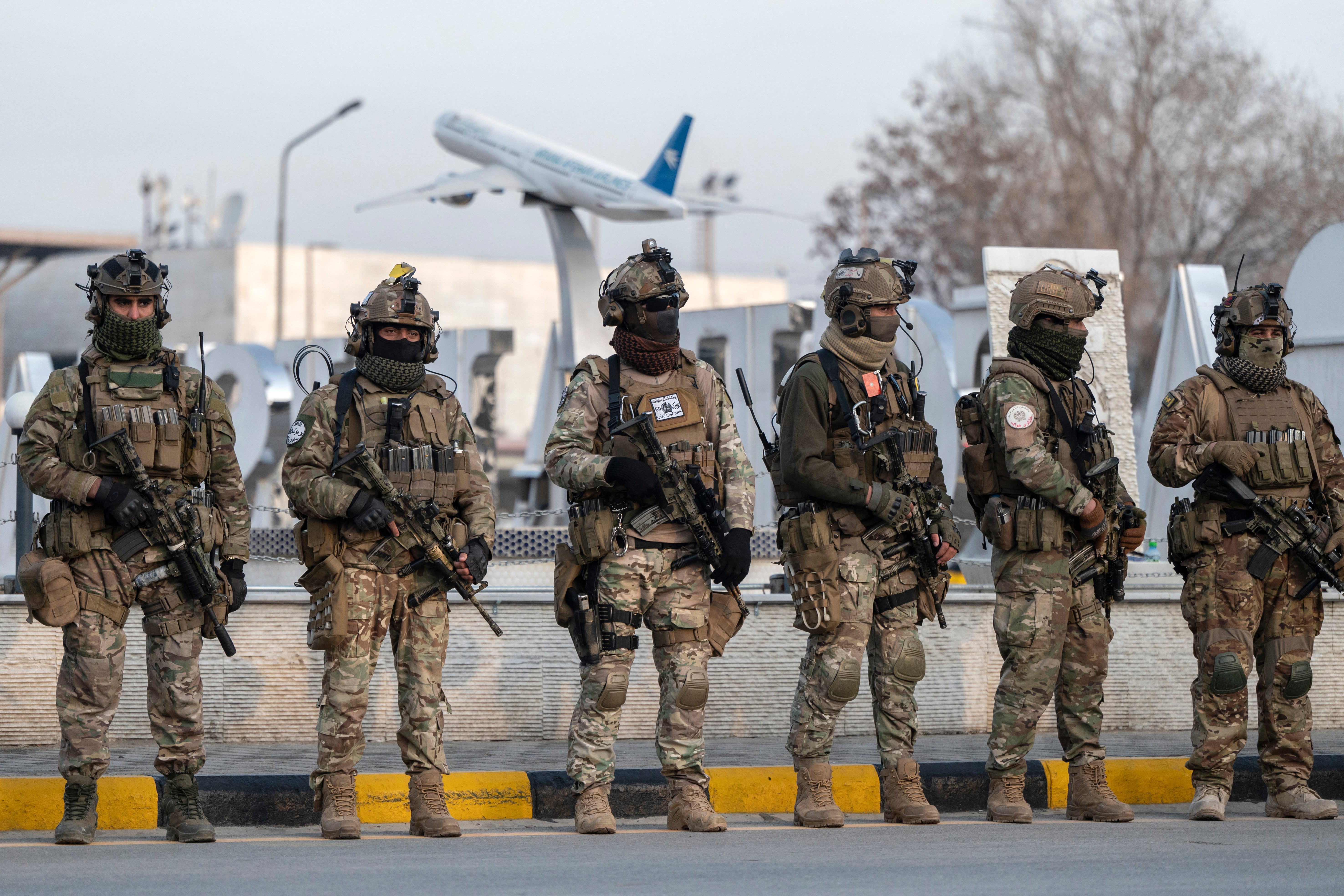 Afghan security personnel stand guard at the Kabul airport
