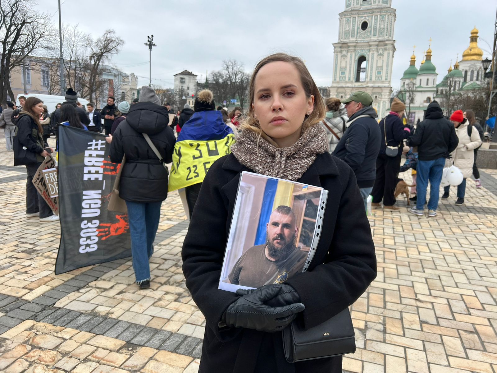 Karina clutches a photo of brother Sasha, held in Russia, at a protest in Kyiv for Ukrainian POWs