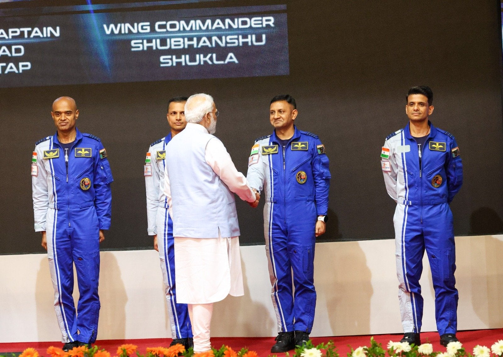 <p>Indian prime minister Narendra Modi hands over hand over token wings to four Indian astronaut-designates</p>