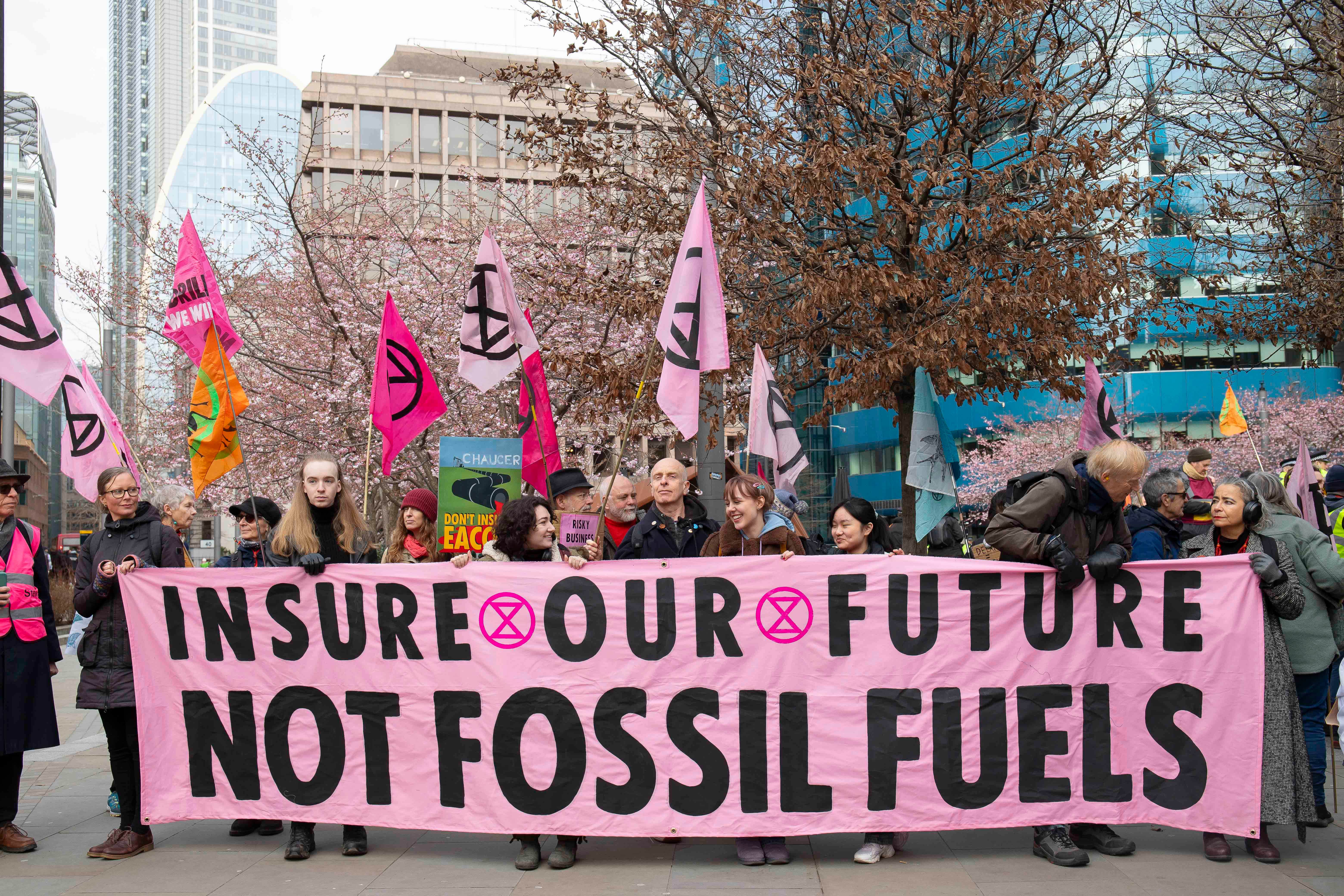 Protesters hold a sign outside the offices of Probitas in London (Expatiate/Extinction Rebellion/PA)