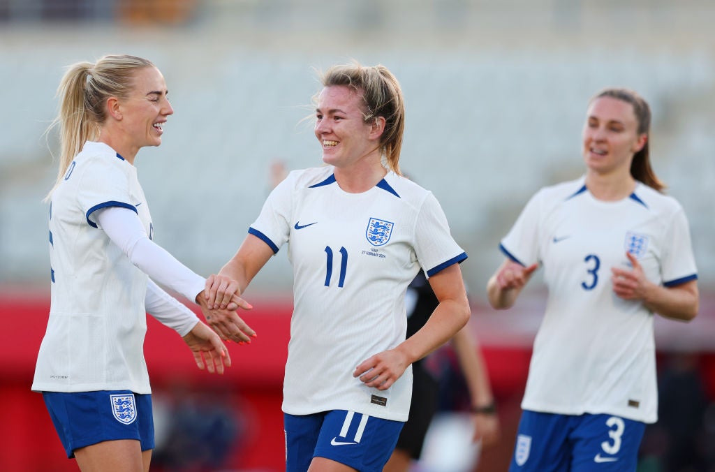 Lauren Hemp, centre, celebrates after scoring the third goal for England