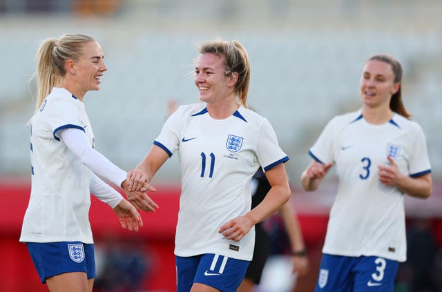 <p>Lauren Hemp, centre, celebrates after scoring the third goal for England</p>