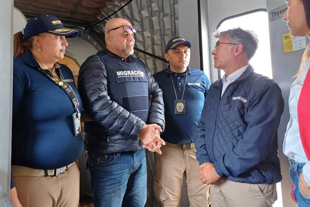 <p>In this photo released by the Colombian Immigration agency, migration officials meet former Colombian paramilitary leader, Salvatore Mancuso, at the gate of the plane at El Dorado International Airport in Bogota, Colombia</p>