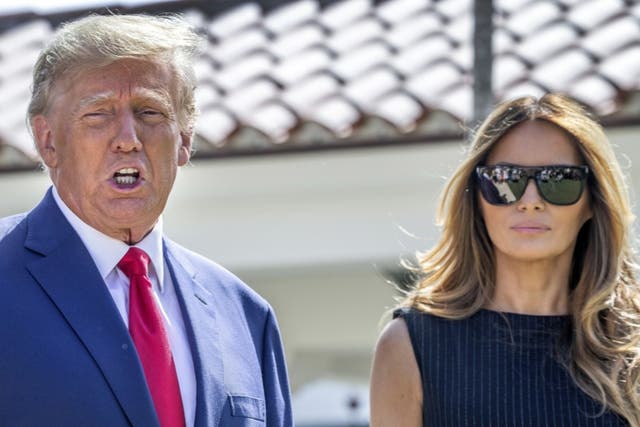 <p>Donald and Melania Trump walk out of a polling station in Palm Beach, Florida, after voting in the 2022 midterm elections</p>
