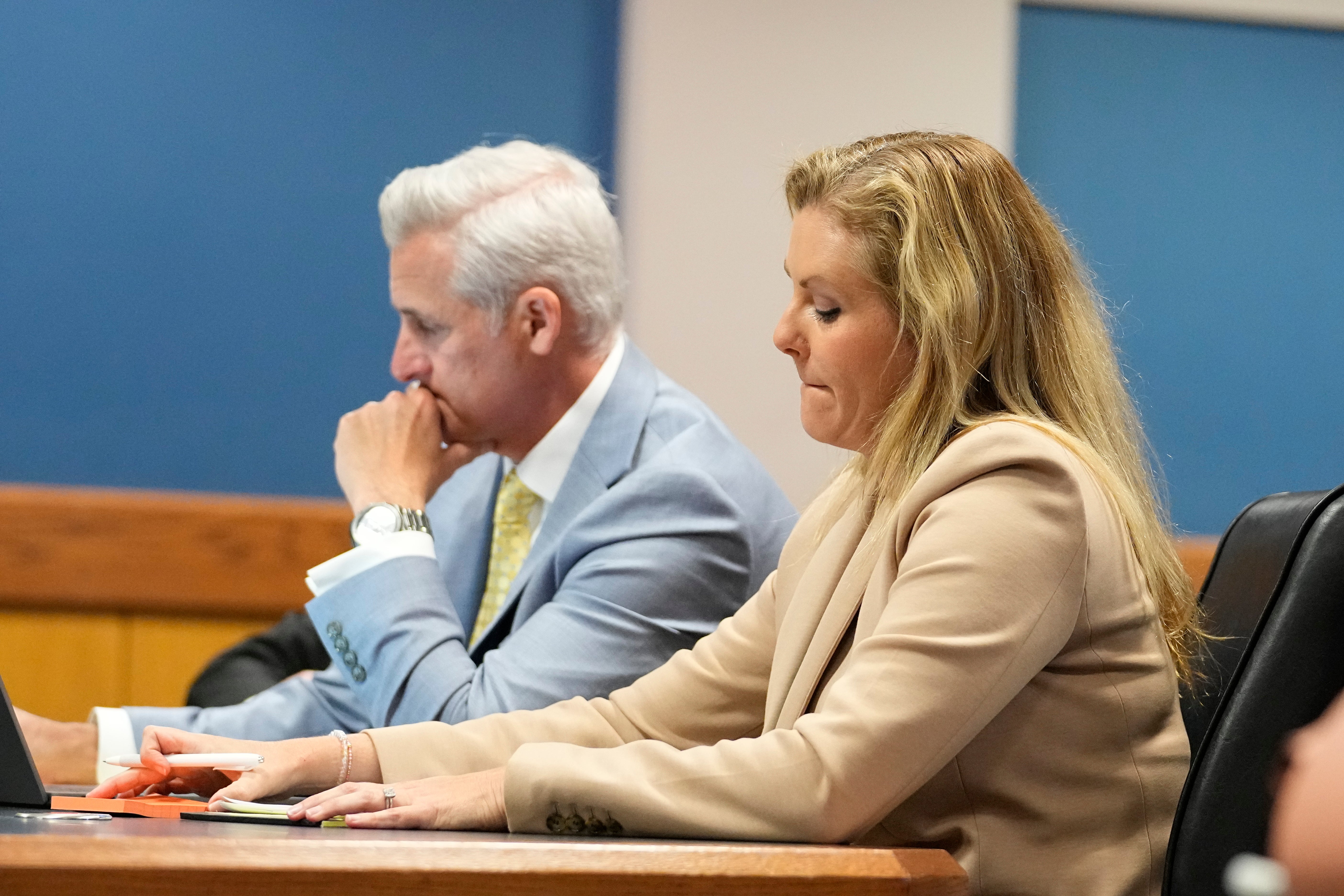 Ashleigh Merchant, right, an attorney for Trump co-defendant Mike Roman, and her husband and law partner John Merchant, left, attend a hearing at the Fulton County courthouse on 27 February