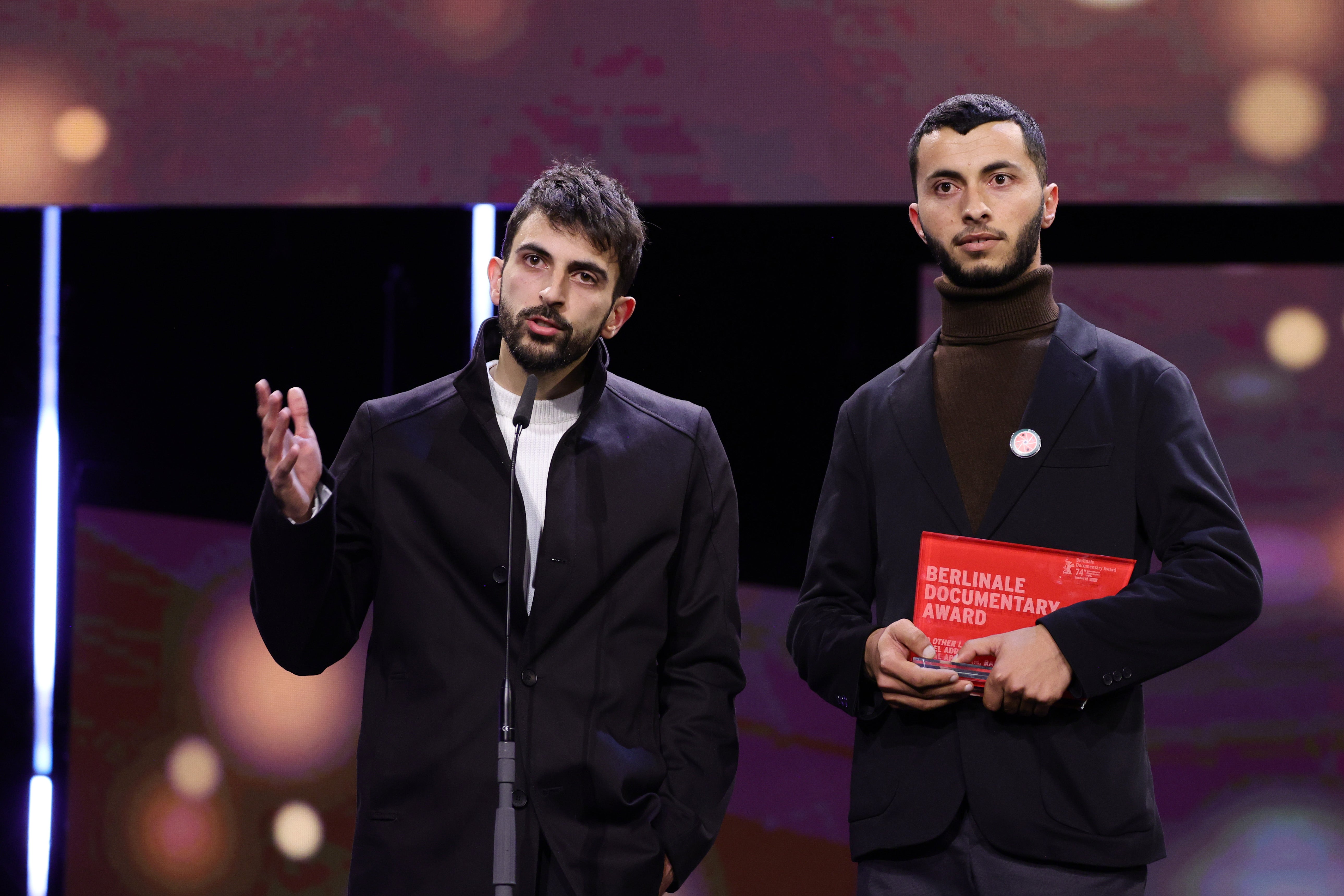<p>Basel Adra (R) and Yuval Abraham speak on stage after winning the Berlinale documentary award for the movie “No Other Land”</p>