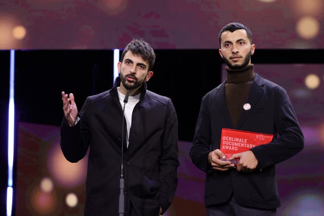 <p>Basel Adra (R) and Yuval Abraham speak on stage after winning the Berlinale documentary award for the movie “No Other Land”</p>