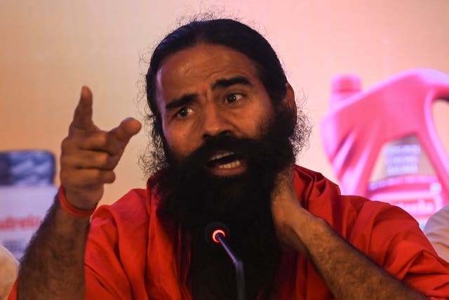 <p>Indian yoga guru and non-executive director of Ruchi Soya Industries Limited (RSIL) Baba Ramdev speaks during an event for the announcement of the company’s forthcoming Follow-on Public Offering (FPO) in Mumbai on 21 March 2022</p>