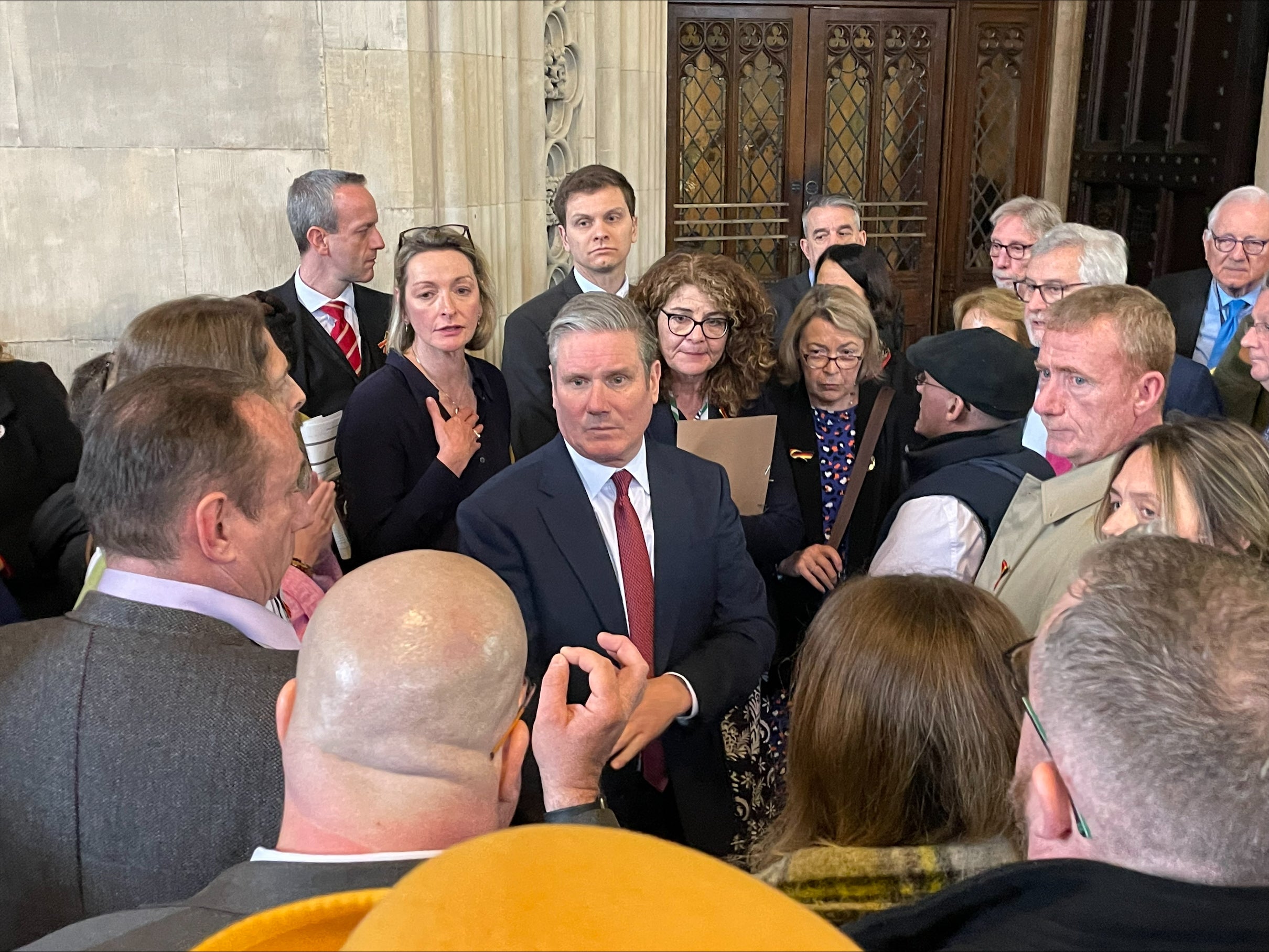 Victims of the infected blood scandal and their relatives surround Sir Keir Starmer in Westminster Hall, February 2024