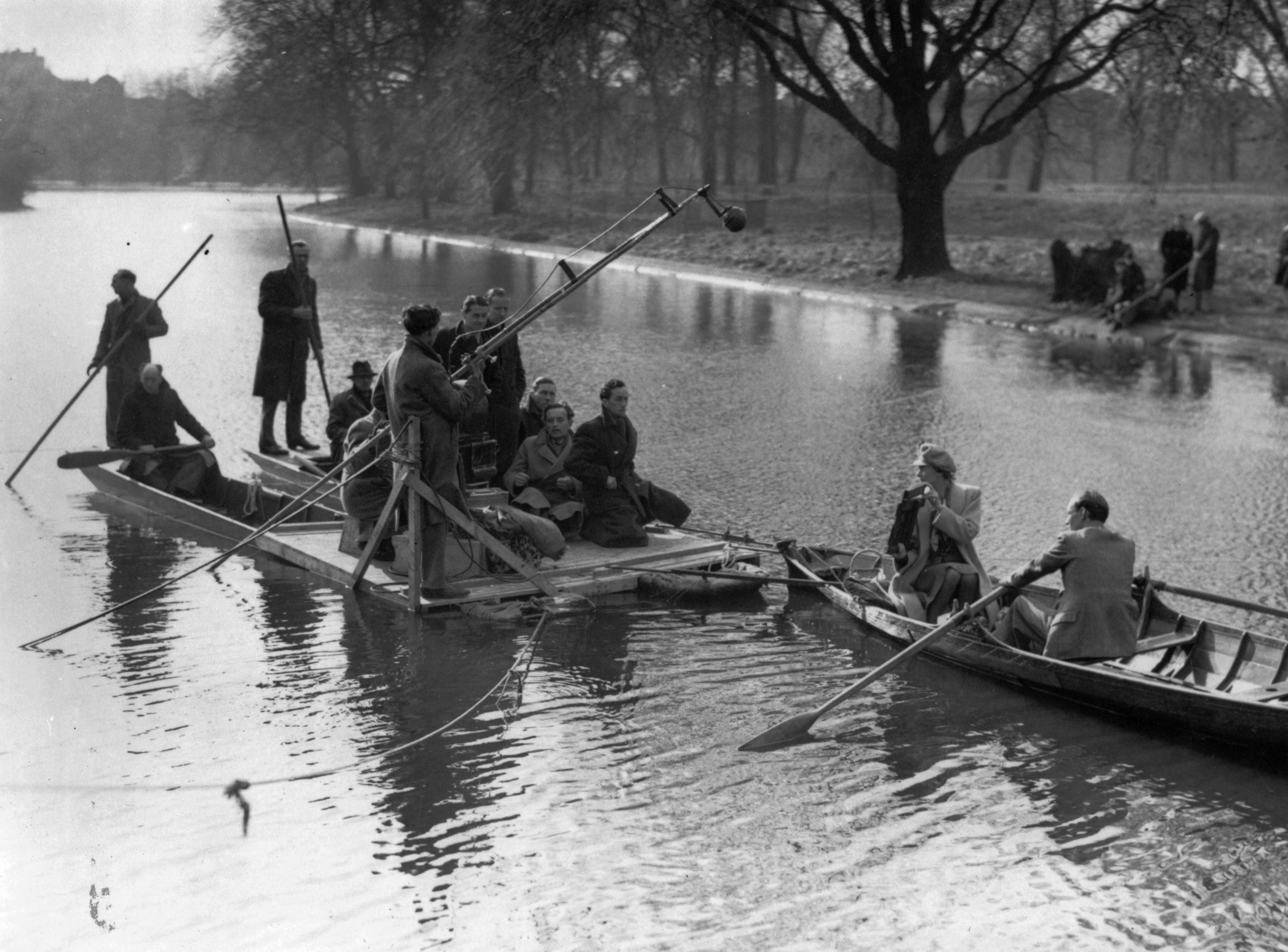 Celia Johnson and Trevor Howard row across a lake followed by a film crew on a floating platform, during a take for ‘Brief Encounter’