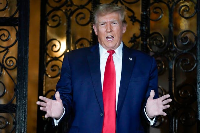<p>Donald Trump speaks to reporters outside Mar-a-Lago’s gates on 16 February</p>