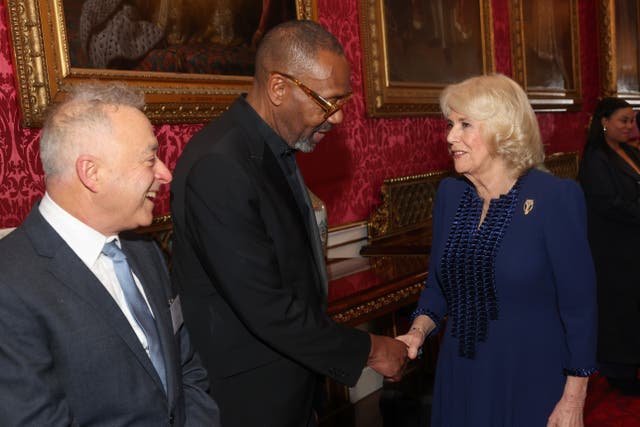 The Queen shakes hands with Sir Lenny Henry during a reception at Buckingham Palace in London with finalists, judges and celebrity readers, to celebrate the final of the BBC’s creative writing competition, 500 Words (Chris Jackson/PA)